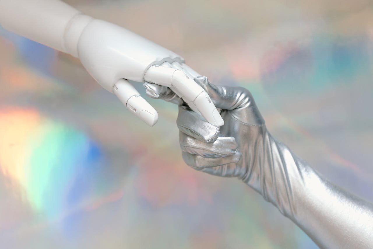 journey Close-up of a robot hand and silver-gloved hand touching, symbolizing human-robot connection.